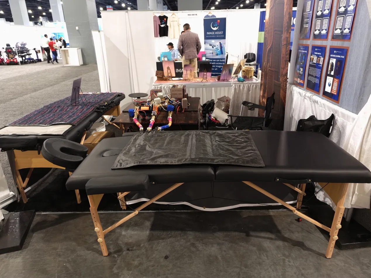 The full Coma Bed treatment table and mat set up at the exhibition booth